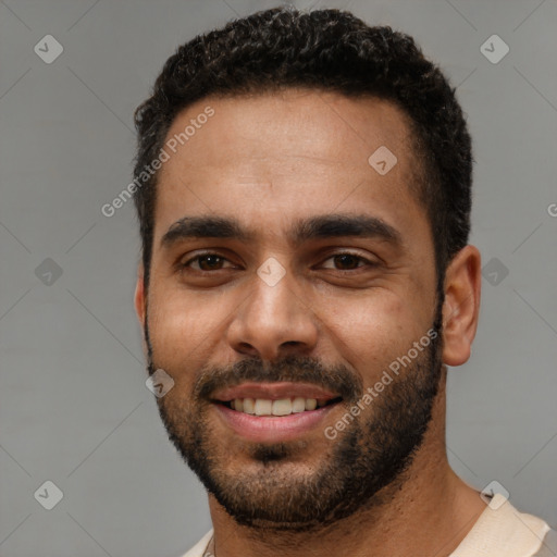 Joyful black young-adult male with short  black hair and brown eyes