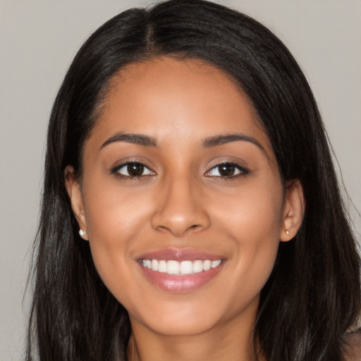 Joyful latino young-adult female with long  black hair and brown eyes