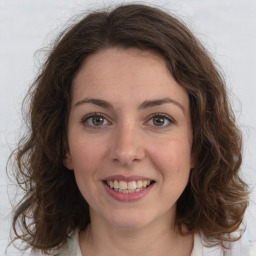 Joyful white young-adult female with medium  brown hair and green eyes