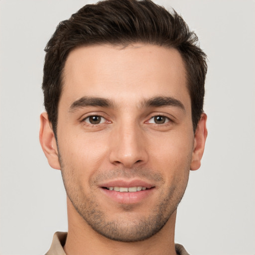 Joyful white young-adult male with short  brown hair and brown eyes