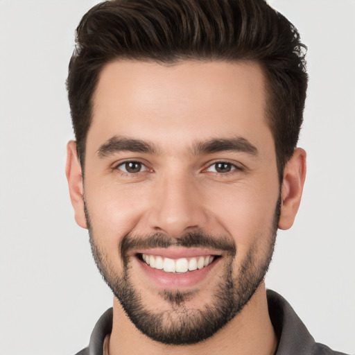 Joyful white young-adult male with short  brown hair and brown eyes