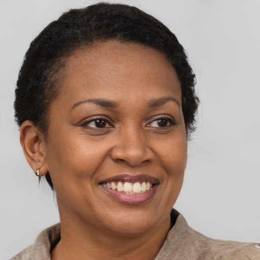 Joyful latino young-adult female with short  brown hair and brown eyes