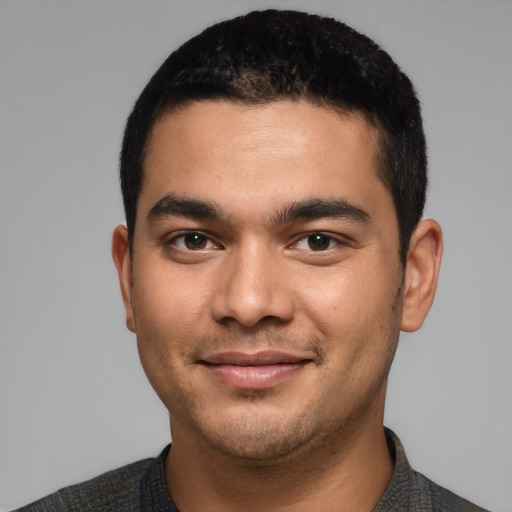 Joyful latino young-adult male with short  brown hair and brown eyes