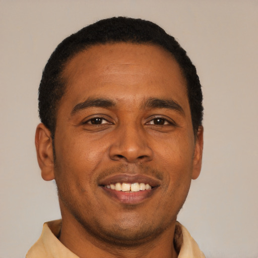 Joyful latino young-adult male with short  brown hair and brown eyes