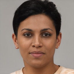 Joyful latino young-adult female with short  black hair and brown eyes