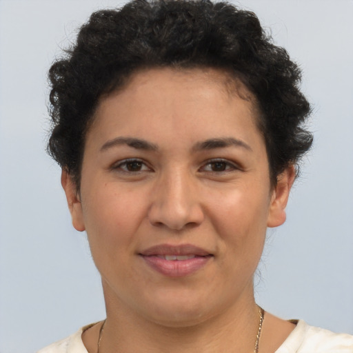 Joyful latino young-adult female with short  brown hair and brown eyes
