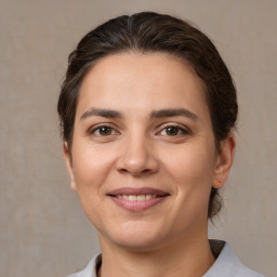 Joyful white young-adult female with medium  brown hair and brown eyes