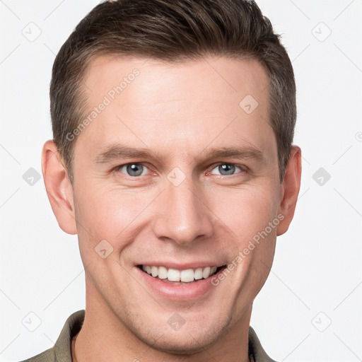 Joyful white young-adult male with short  brown hair and grey eyes