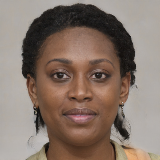 Joyful black adult female with short  brown hair and brown eyes