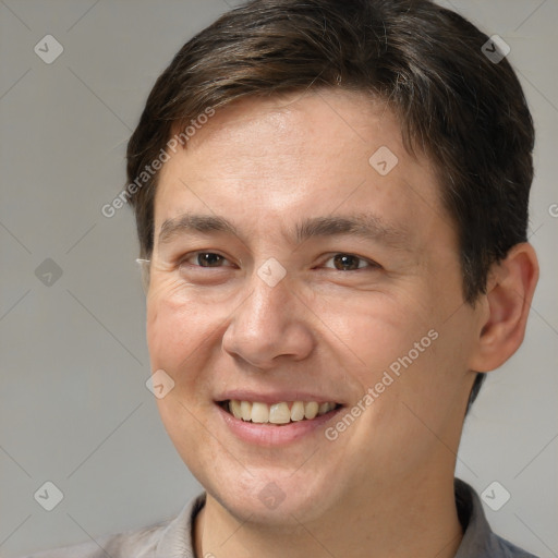 Joyful white adult male with short  brown hair and brown eyes