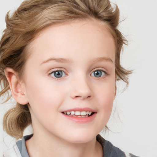 Joyful white child female with medium  brown hair and blue eyes