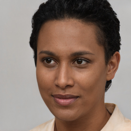 Joyful latino young-adult female with short  brown hair and brown eyes