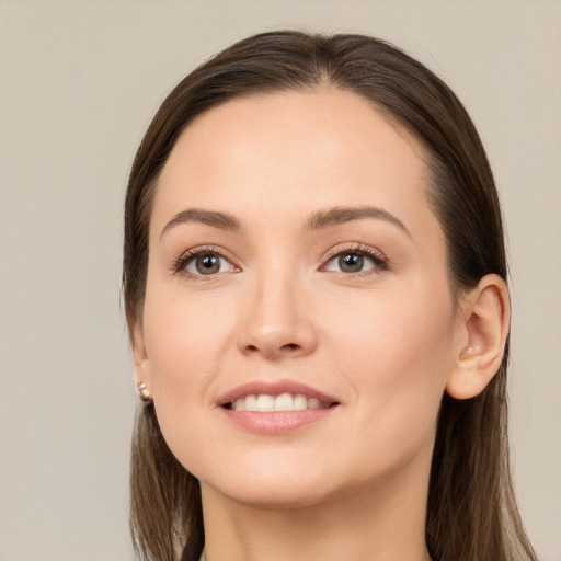 Joyful white young-adult female with long  brown hair and brown eyes