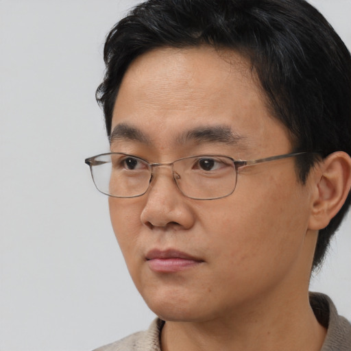 Neutral asian adult male with short  black hair and brown eyes
