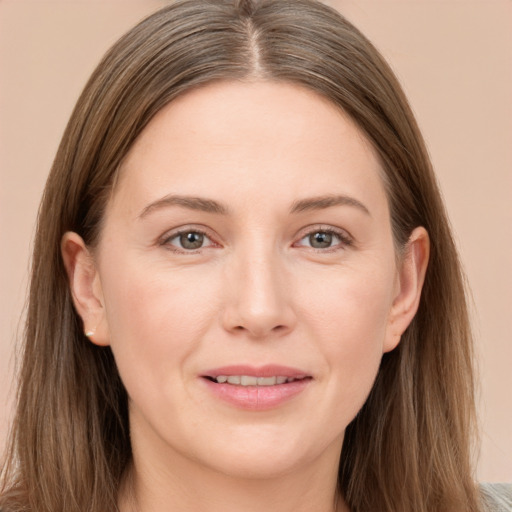 Joyful white young-adult female with long  brown hair and grey eyes