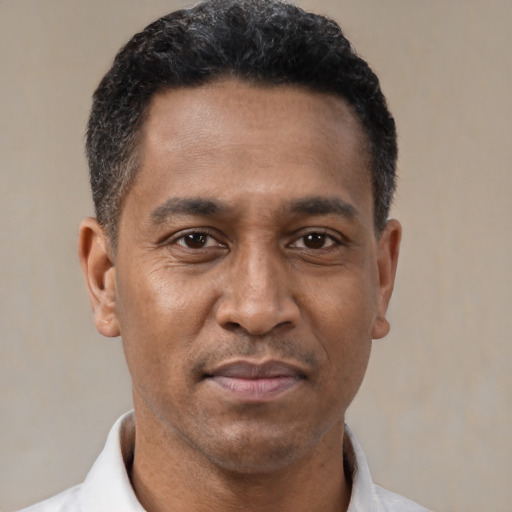 Neutral latino adult male with short  black hair and brown eyes