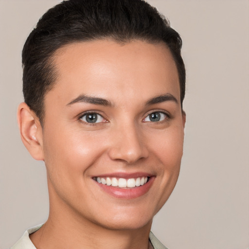 Joyful white young-adult female with short  brown hair and brown eyes