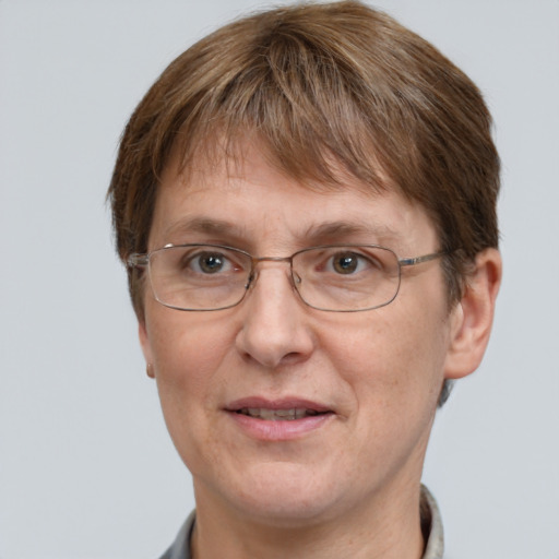 Joyful white adult female with short  brown hair and grey eyes