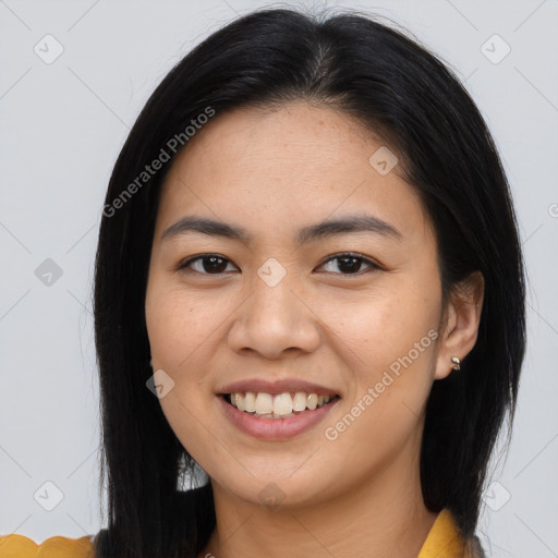 Joyful asian young-adult female with long  brown hair and brown eyes