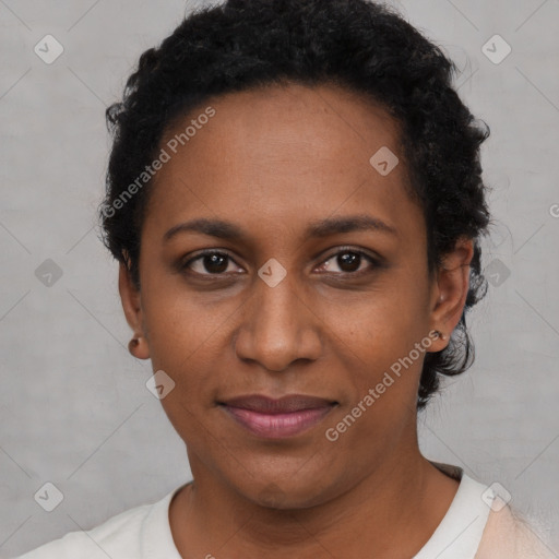 Joyful black young-adult female with short  brown hair and brown eyes