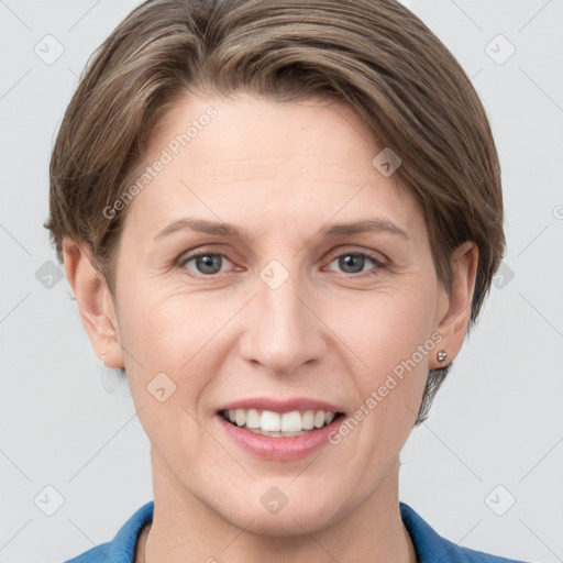 Joyful white adult female with short  brown hair and grey eyes