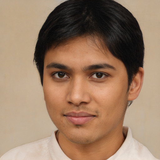 Joyful latino young-adult male with short  brown hair and brown eyes