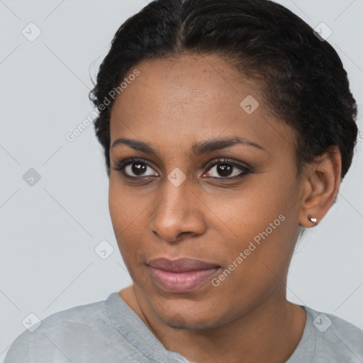 Joyful black young-adult female with short  brown hair and brown eyes