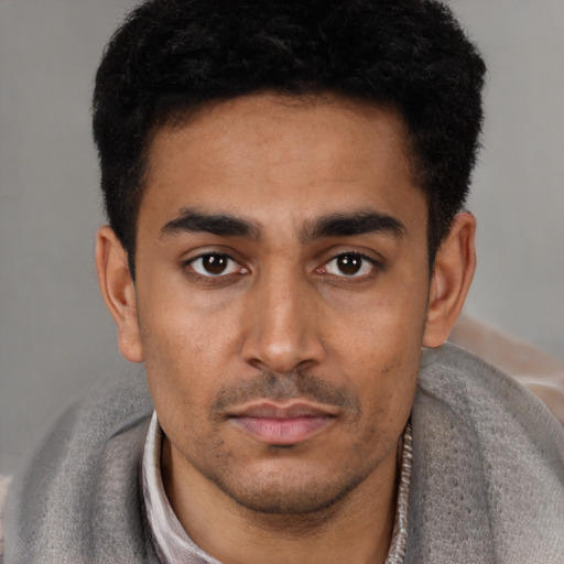 Neutral latino young-adult male with short  black hair and brown eyes