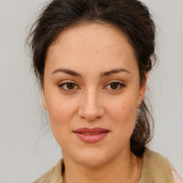 Joyful white young-adult female with medium  brown hair and brown eyes