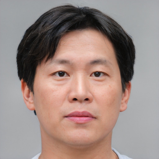 Neutral asian adult male with short  brown hair and brown eyes