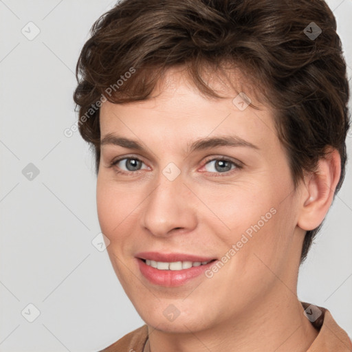 Joyful white young-adult female with short  brown hair and grey eyes