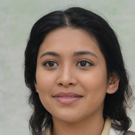 Joyful latino young-adult female with medium  brown hair and brown eyes