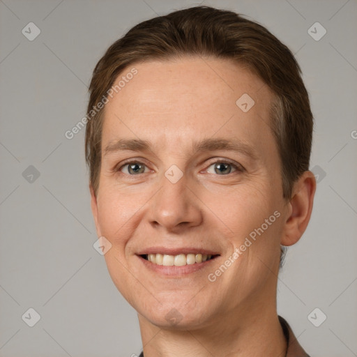 Joyful white adult male with short  brown hair and grey eyes