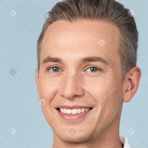 Joyful white adult male with short  brown hair and brown eyes