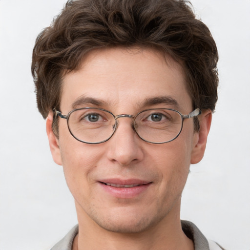 Joyful white adult male with short  brown hair and grey eyes