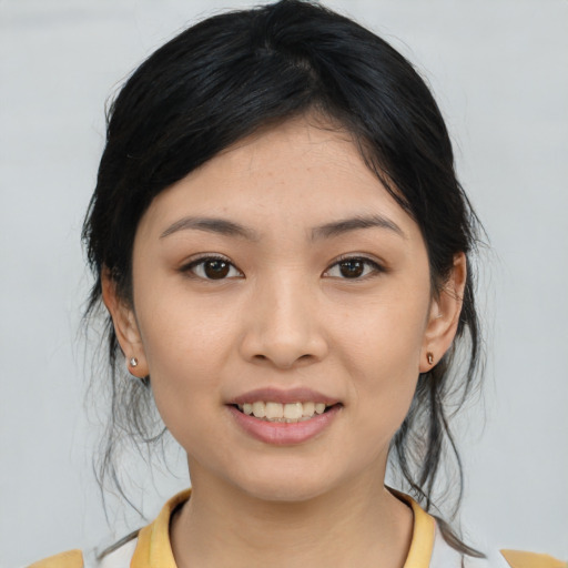 Joyful asian young-adult female with medium  black hair and brown eyes