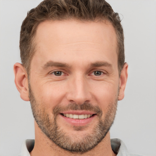 Joyful white adult male with short  brown hair and brown eyes