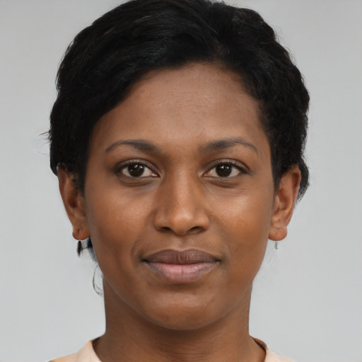 Joyful black young-adult female with short  black hair and brown eyes