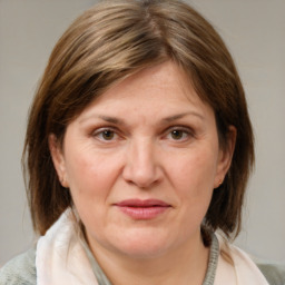 Joyful white adult female with medium  brown hair and grey eyes