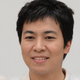 Joyful asian young-adult male with short  brown hair and brown eyes