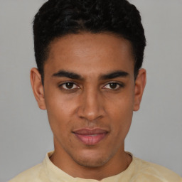 Joyful latino young-adult male with short  brown hair and brown eyes