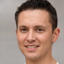 Joyful white adult male with short  brown hair and brown eyes