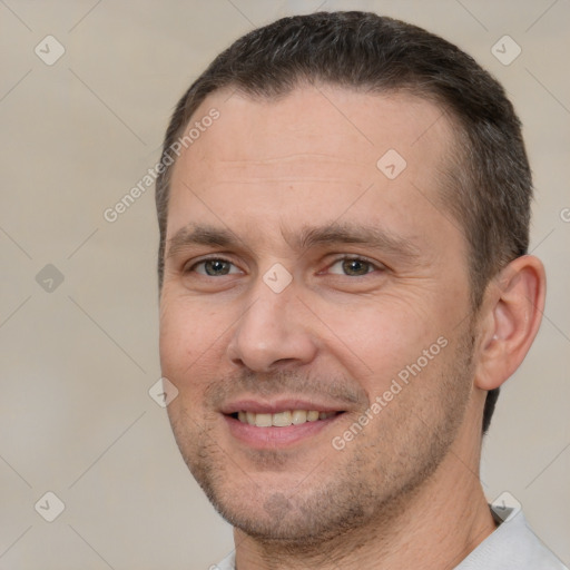 Joyful white adult male with short  brown hair and brown eyes