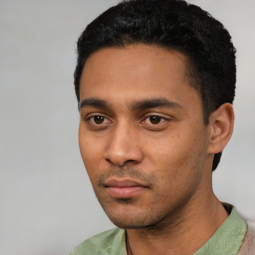 Neutral latino young-adult male with short  black hair and brown eyes