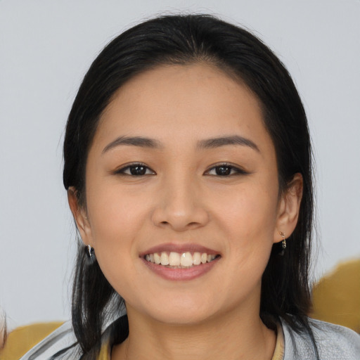 Joyful asian young-adult female with medium  black hair and brown eyes