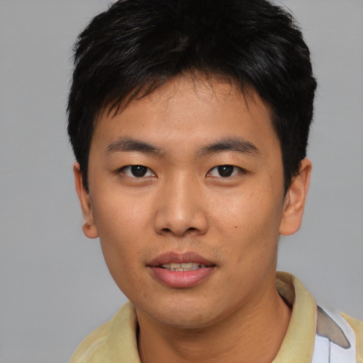 Joyful asian young-adult male with short  black hair and brown eyes