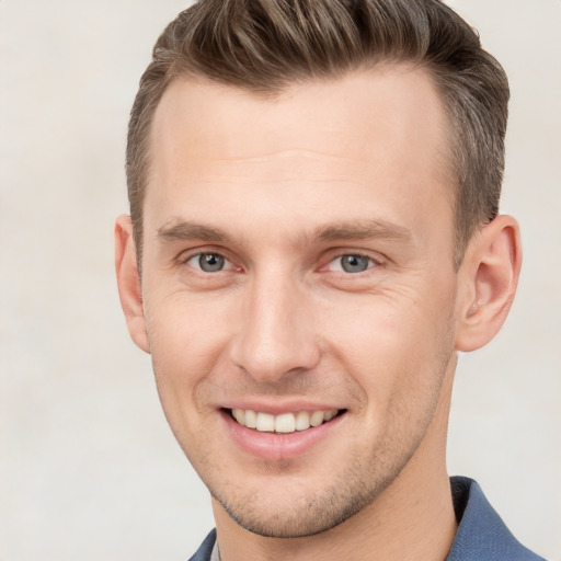 Joyful white young-adult male with short  brown hair and grey eyes