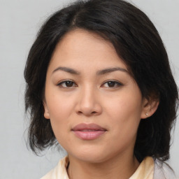 Joyful asian young-adult female with medium  brown hair and brown eyes