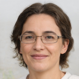 Joyful white adult female with medium  brown hair and brown eyes