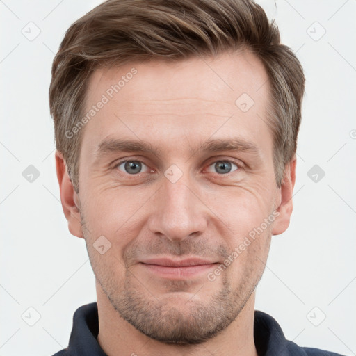 Joyful white adult male with short  brown hair and grey eyes